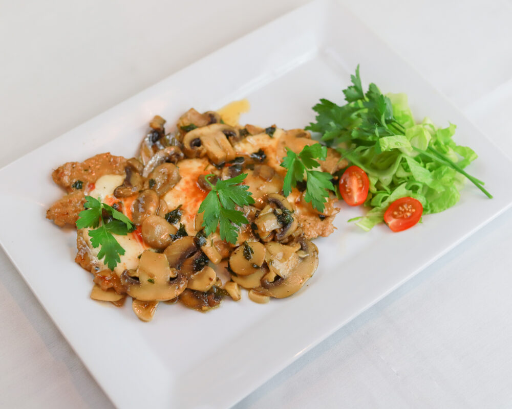 Our Signature Pollo Mamma Lucia- Organic Chicken sautéed in marsala wine with mushroom topped prosciutto, onions with mozzarella